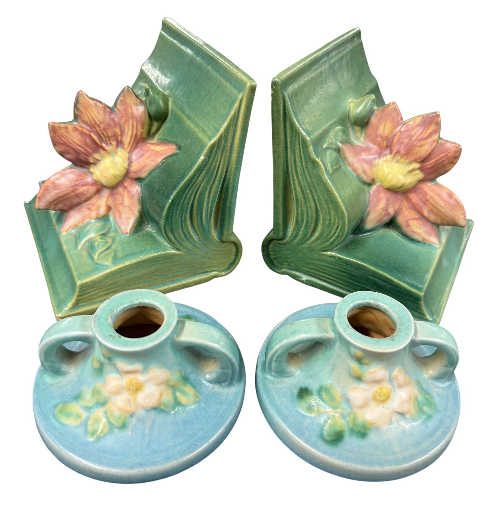 Roseville Clematis Bookends, White Rose Candlesticks: Roseville Clematis Bookends, White Rose Candlesticks. Roseville #14 Clematis Bookends, old repair to one corner. White Rose candlesticks, #1141.