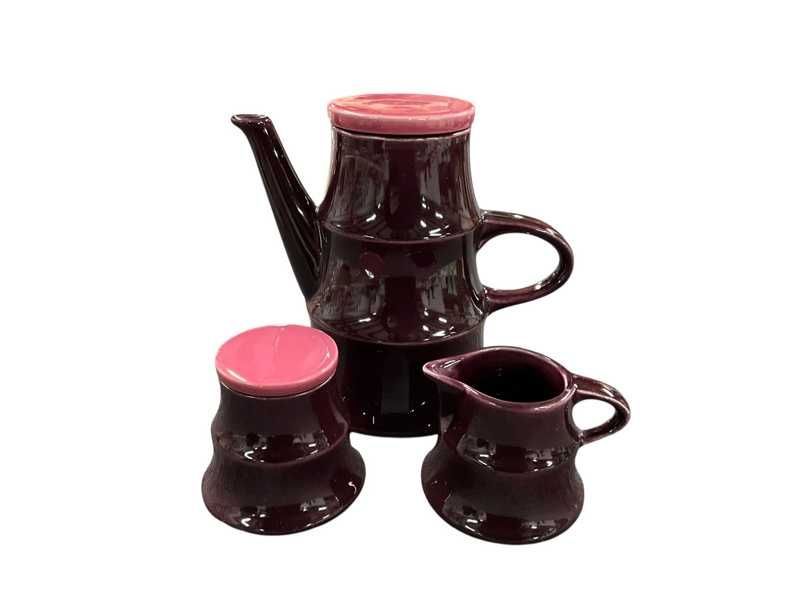 Staffel Tea Set: Staffel Tea Set. Unusual violet glaze with pink flat top lids for teapot and sugar bowl. Teapot is approx. 7.5" tall. Partially obscured ink stamp on bottom- "Staffel" is about all we can make out.