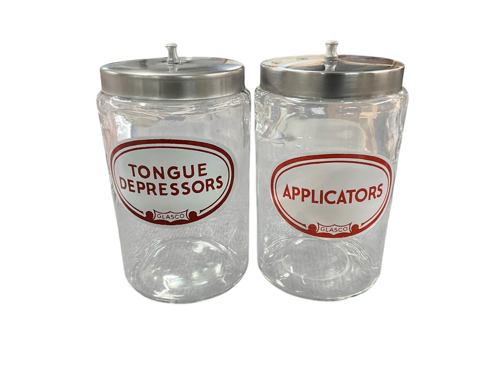 Pair of Covered Medical Jars: Pair of Covered Medical Jars. Glasco 8" Jars- One Marked "Tongue Depressors," and one marked "Applicators."