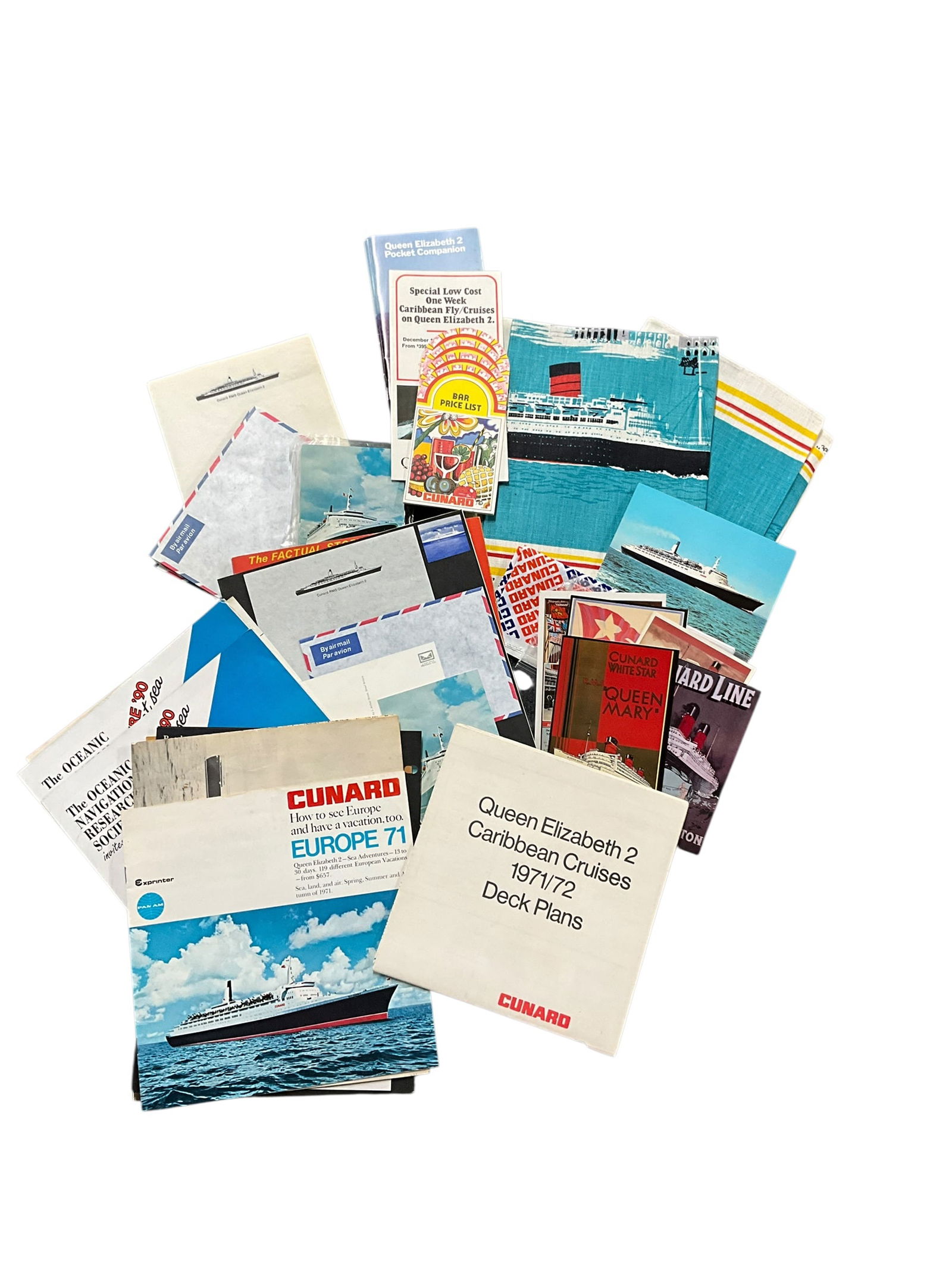 Queen Elizabeth 2/Cunard Ephemera: Queen Elizabeth 2/Cunard Ephemera. Stationery, airmail envelopes, deck plans, brochures, postcards, souvenir towels, etc. See photos for complete inventory.