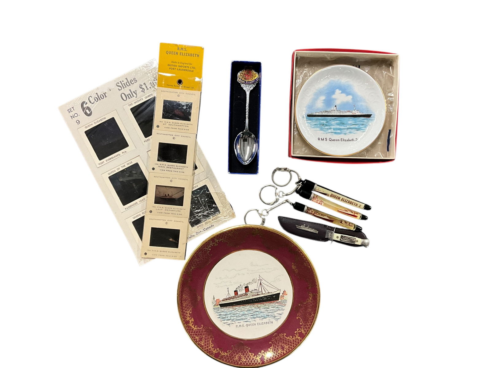 Queen Elizabeth 2/Cunard Souvenir Items: Queen Elizabeth 2/Cunard Souvenir Items. Spoon, knife, key rings, plates, color slides.