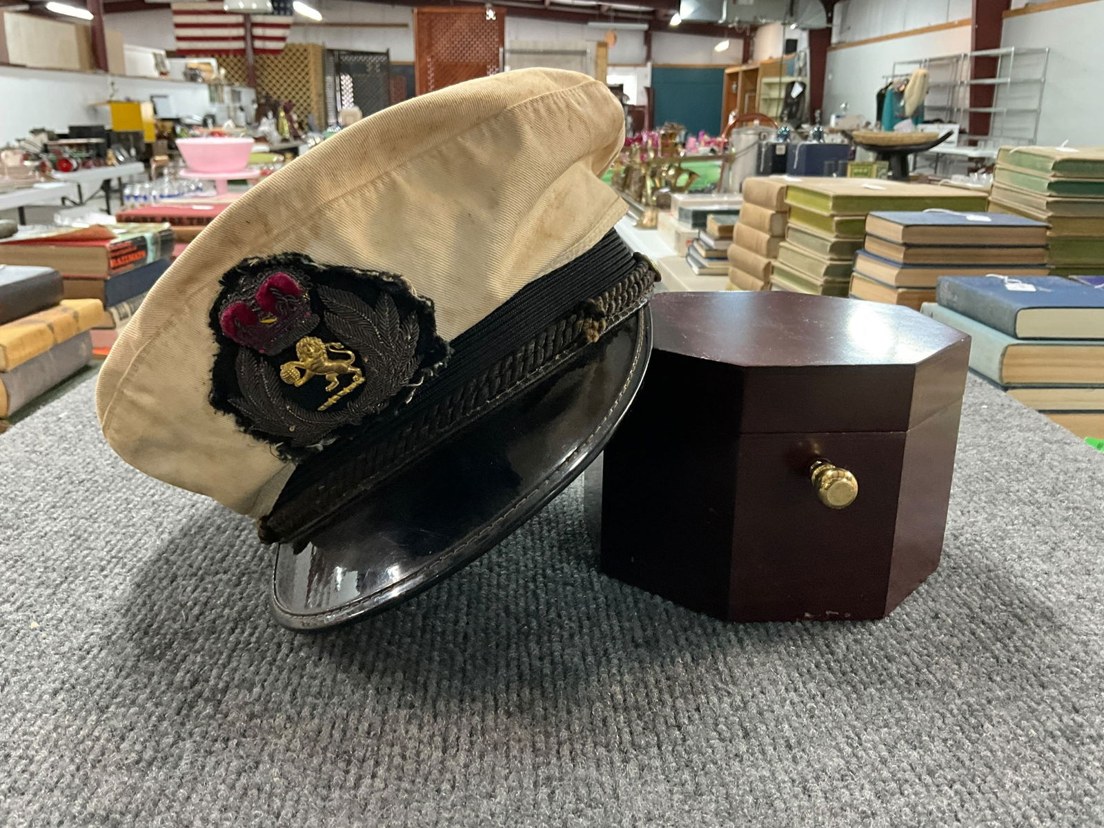 SS Keewatin Centennial Clock, and British Royal Navy Cap: SS Keewatin Centennial Clock, and British Royal Navy Cap. Clock case is marked SS Keewatin 100th Anniversary, 1907-2007. British Royal Navy Cap likely dates from the WWII era. Cap has soiling fading,