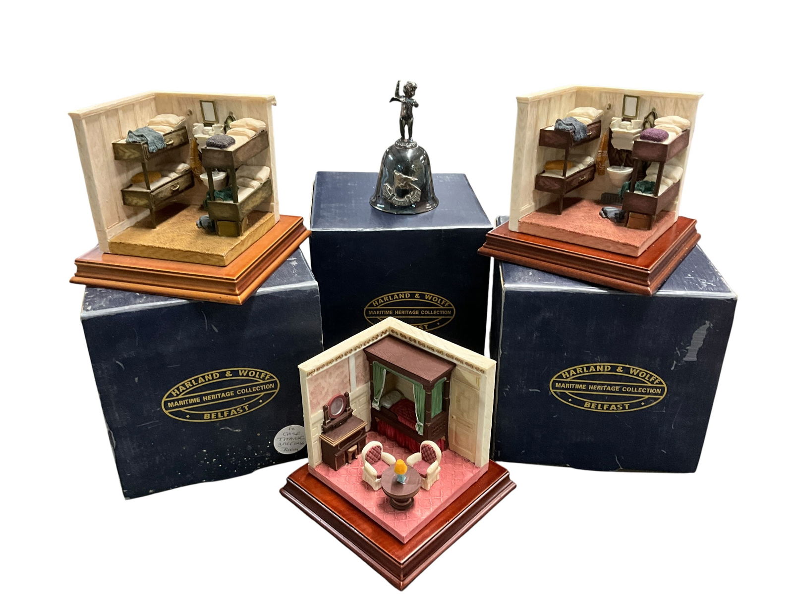 Titanic Collectibles Lot: Titanic Collectibles Lot. A White Star Line silver plate bell, and three 3 dimensional models of Titanic passenger cabins- two first Class staterooms and a Third Class cabin.