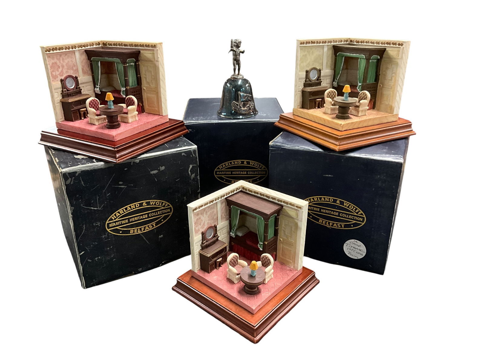 Titanic Collectibles Lot: Titanic Collectibles Lot. A White Star Line silver plate bell, and three 3 dimensional models of Titanic passenger cabins- all first Class staterooms.