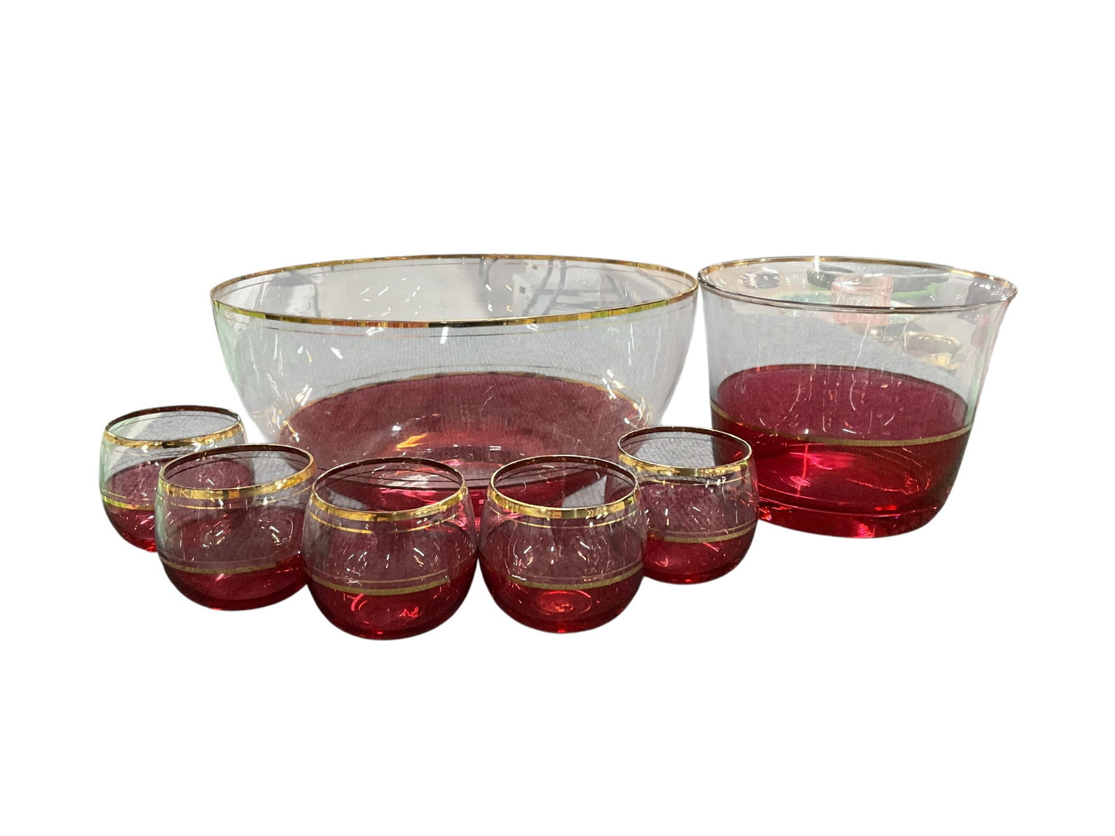 Cranberry Glass Lot: Cranberry Lot. Cranberry/clear punch set with gold banding and rims. a 10" punch bowl, five 2.5" glasses, and a separate 6.5" bowl that could be an ice bucket.