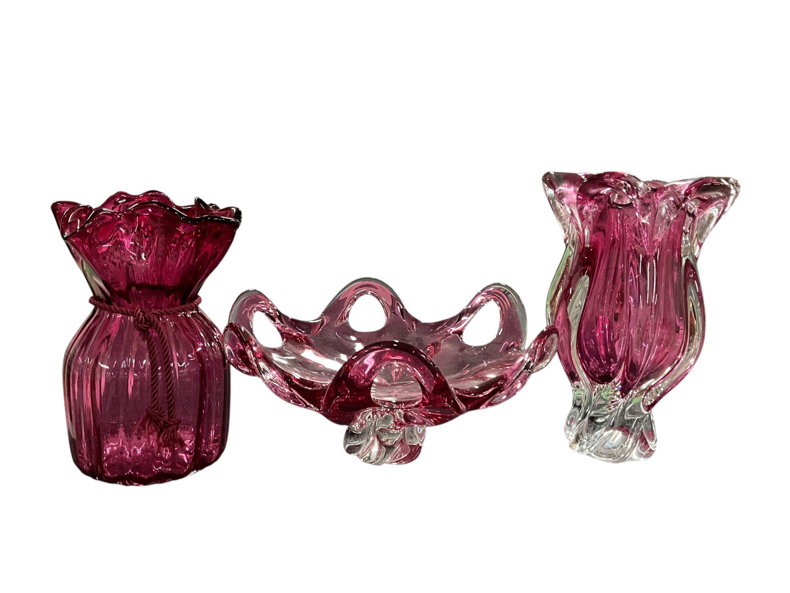Cranberry Glass Lot: Cranberry Lot. An 8.5" Fenton cinch or sack style vase, and a Murano or possibly Czechoslovakian pulled loop vase and footed bowl. The vase has a chip in the base.