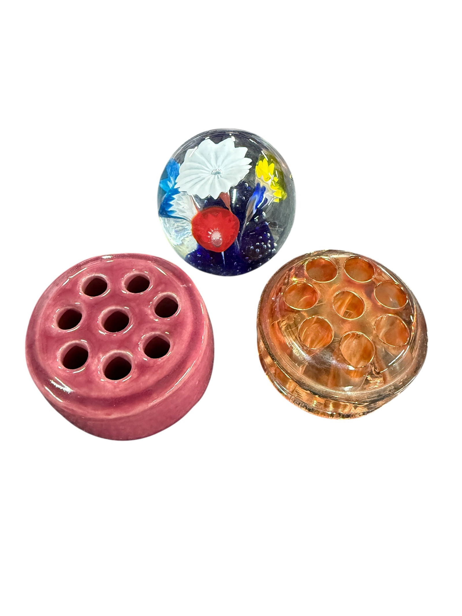 Flower Frogs, Paperweight: Flower Frogs, Paperweight. An amber carnival glass flower frog, another frog in pink ceramic, and an unmarked floral paperweight.