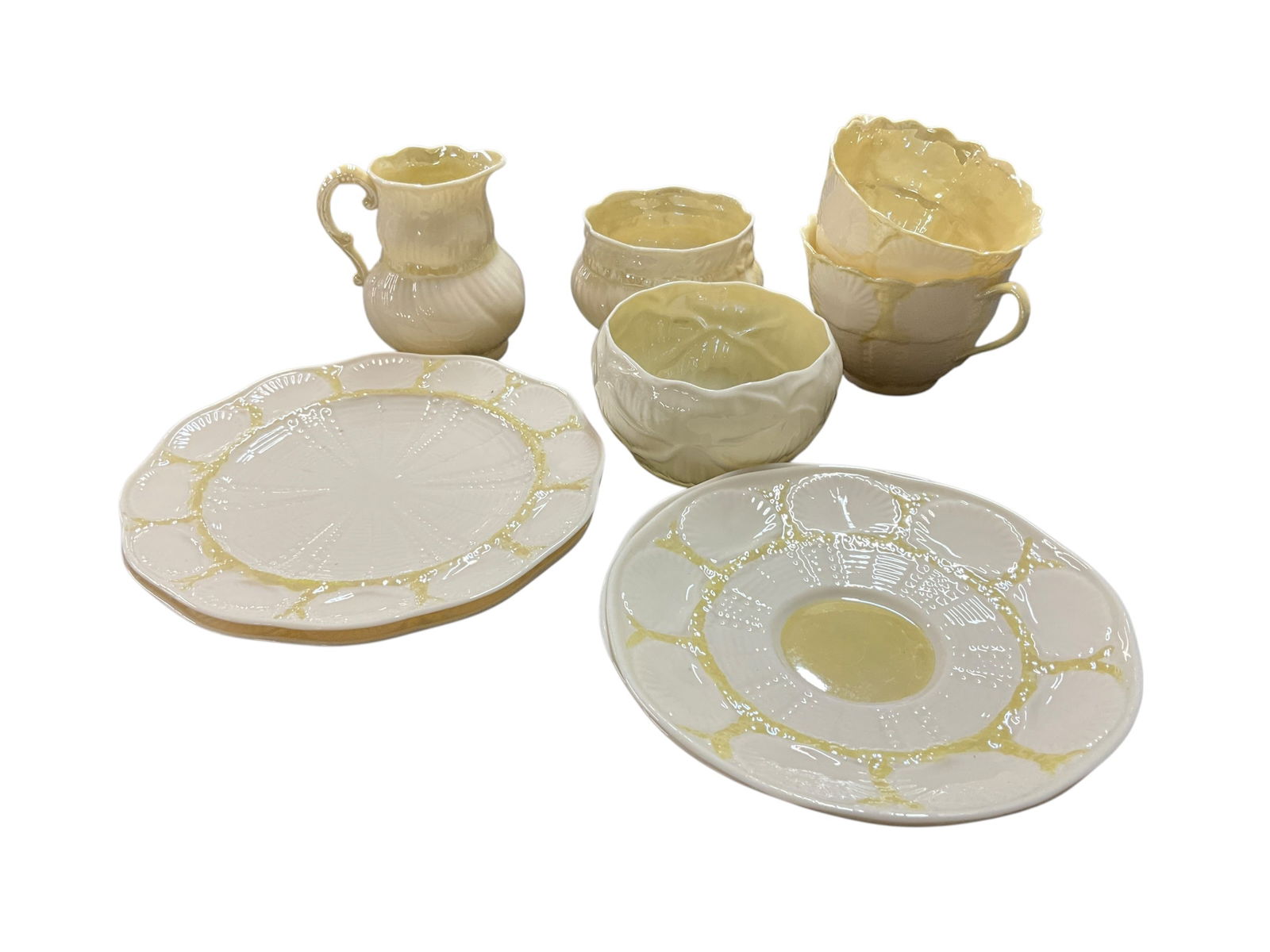 Collection of Belleek China: Irish Belleek china in the New Shell Pattern. The Belleek New Shell pattern is a classic collection of Irish Parian china characterized by its translucent finish, embossed shell motifs, and coral-insp
