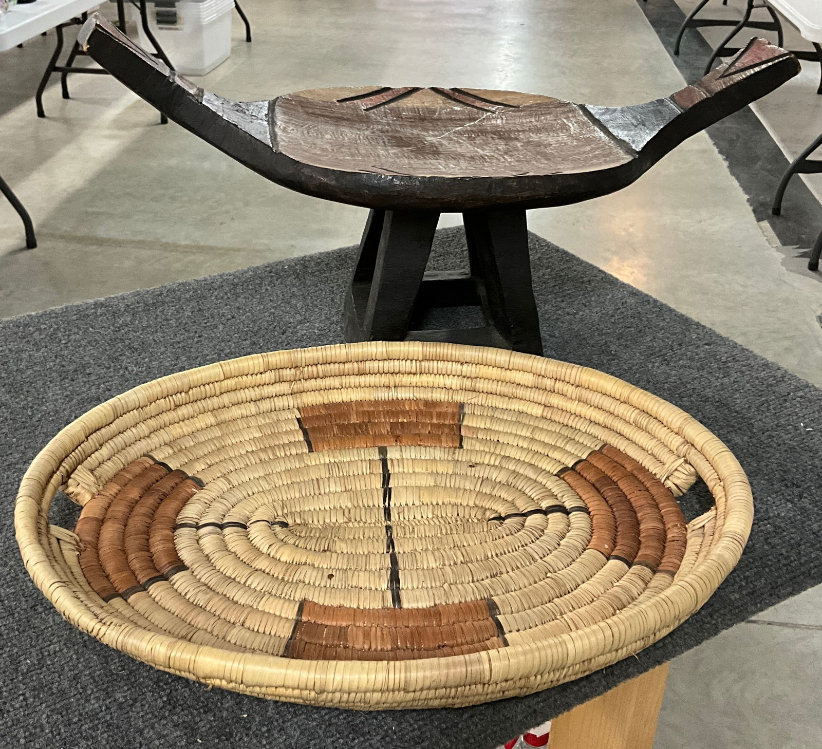 African Stool and Grass Basket: Vintage carved Zambian Stool-very sturdy and adorned with carved and burnt detail. Woven wheatgrass flat basket/tray.