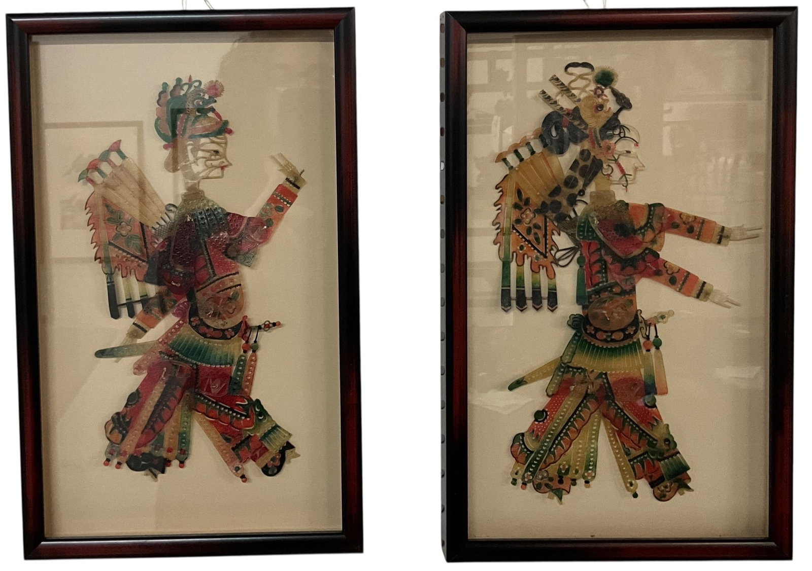 Pair of Framed Chinese Shadow Puppets: Pair of Framed Chinese Shadow Puppets. Measuring from approx. 10"-12" tall inside a pair of 15.25" X 9.5" frames, these colorful and intricately detailed puppets represent a traditional Chinese art fo