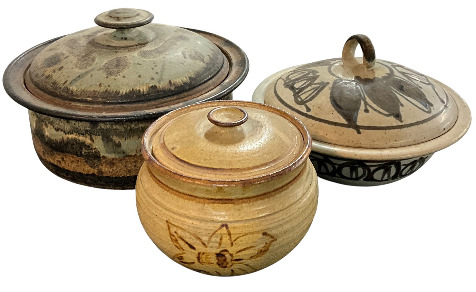 Three Art Pottery Covered Casserole Dishes: Three Art Pottery Covered Casserole Dishes. The largest, 10.75" diameter, is signed "Gary Hart." the 9.25" diameter dish is inscribed "JT" in a circle, and the smallest, 6" diameter, is unmarked.