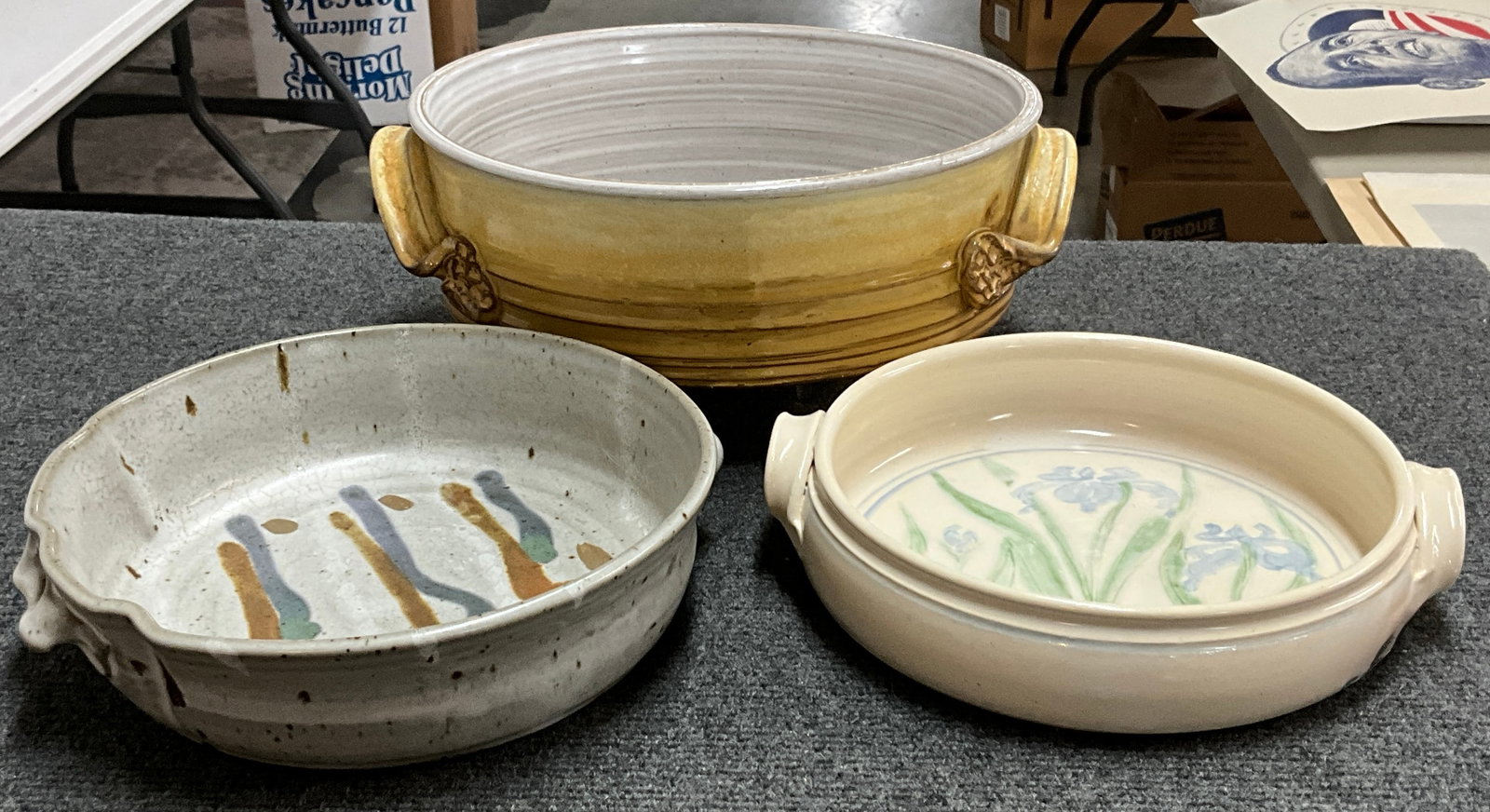 Trio of Art Pottery Casserole/Gratin Pans: The deepest pot is 11"x10"x4" and is big enough to comfortably roast a chicken. The pale pan adorned with purple irises and measures 9"x2". The ruffle edged stoneware is asymmetrical, with ruffles or