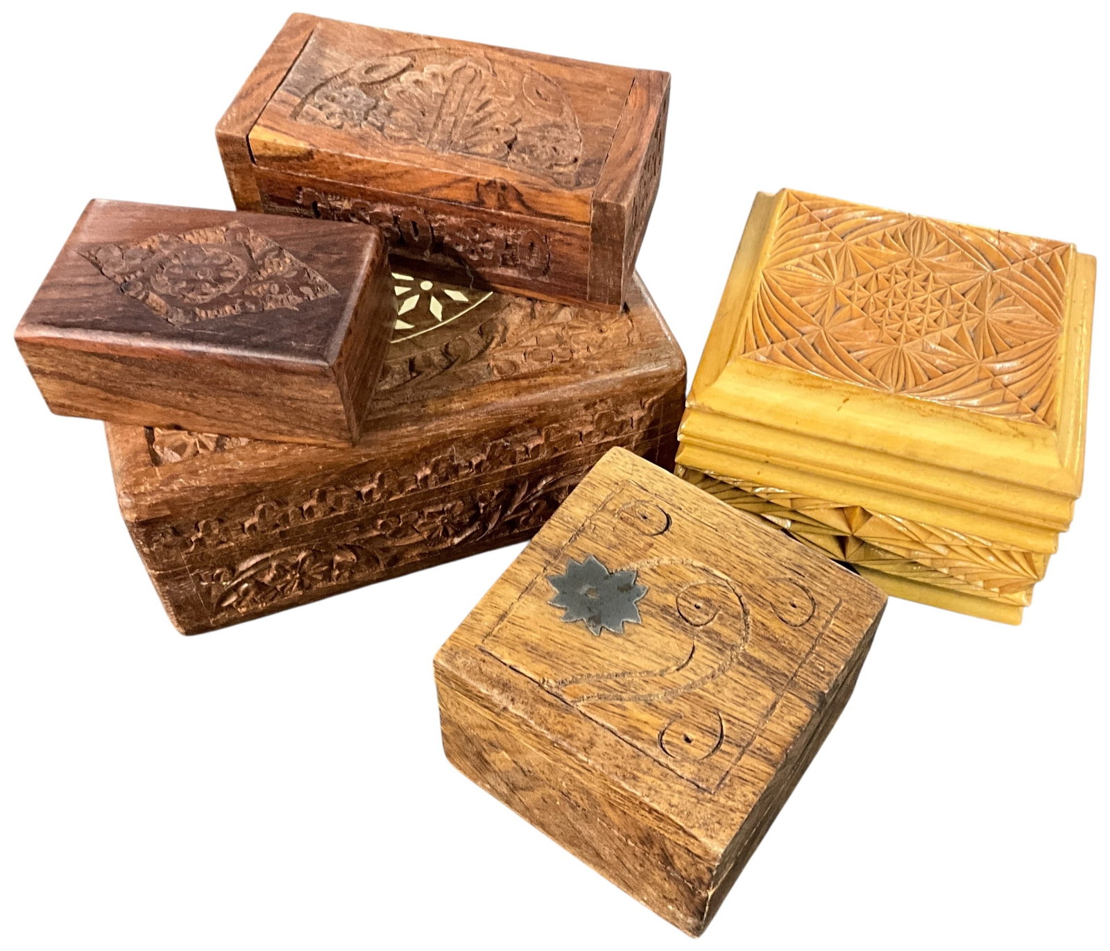 Group of Hand-Carved Wooden Trinket Boxes with Decorative Motifs: Collection of five hand-carved wooden trinket boxes featuring a variety of traditional and folk-art designs. Includes intricately carved floral and geometric patterns, relief carvings, and one box wit