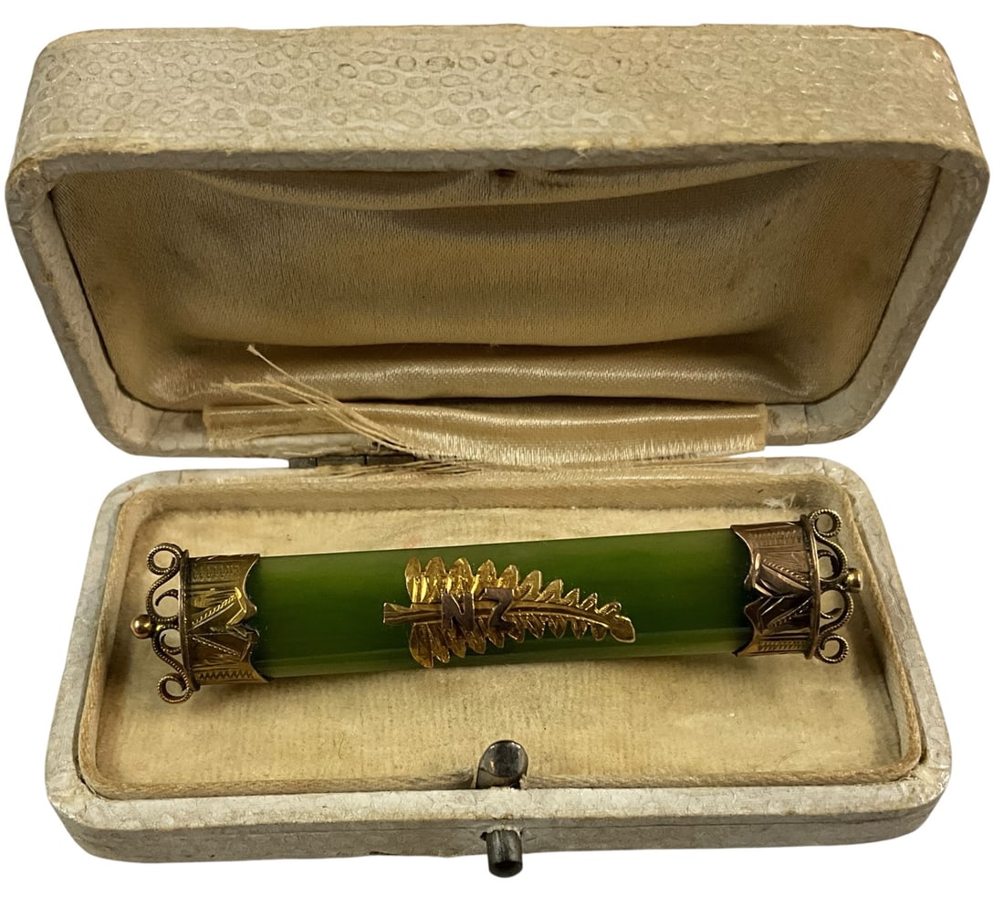 Vintage Green Stone Bar Brooch with Gold Tone Mount in Original Case: Vintage bar brooch featuring a polished green stone panel, likely jade or jadeite-style, set within an ornate gold tone frame with central leaf motif. The brooch is presented in its original fitted ca