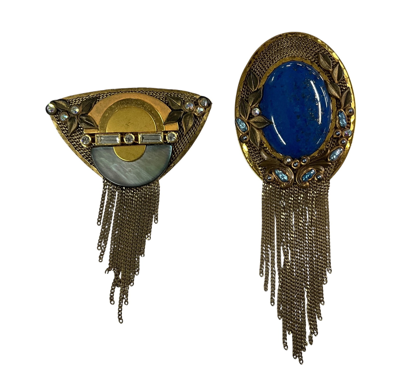 Marena Art Deco Revival Brooches (2) with Blue Cabochon, Mother-of-Pearl & Chain Fringe – Germany: Pair of Marena Art Deco Revival brooches featuring ornate gilt metal construction and chain fringe. Includes blue cabochon brooch and fan-shaped mother-of-pearl brooch with rhinestone accents. Both pi