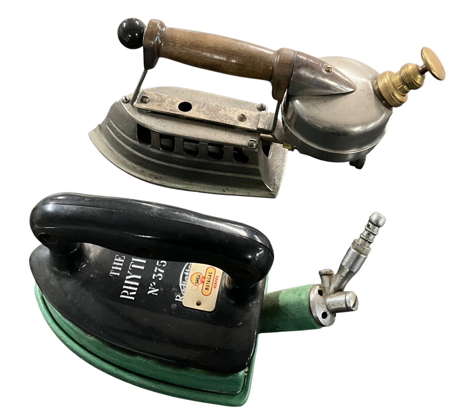 Two Vintage Fuel Irons Including Gasoline Iron and --The Rhythm No. 375U-? Butane Iron: Lot of two vintage fuel-operated irons including one gasoline-powered iron and one butane gas iron marked --The Rhythm No. 375U.-? The first iron is an earlier gasoline-powered example featuring a cas