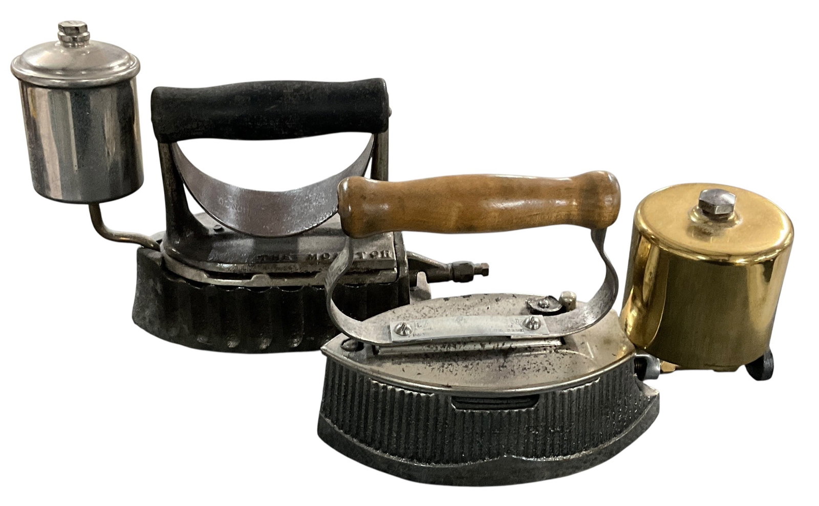 Two Antique Gasoline Irons Including --The Monitor-? and Early Fuel Iron with Brass Tank: Lot of two antique gasoline-powered irons including one example marked --The Monitor-? and a second early fuel iron with brass tank. The first iron is a cast iron gasoline model marked --The Monitor,-