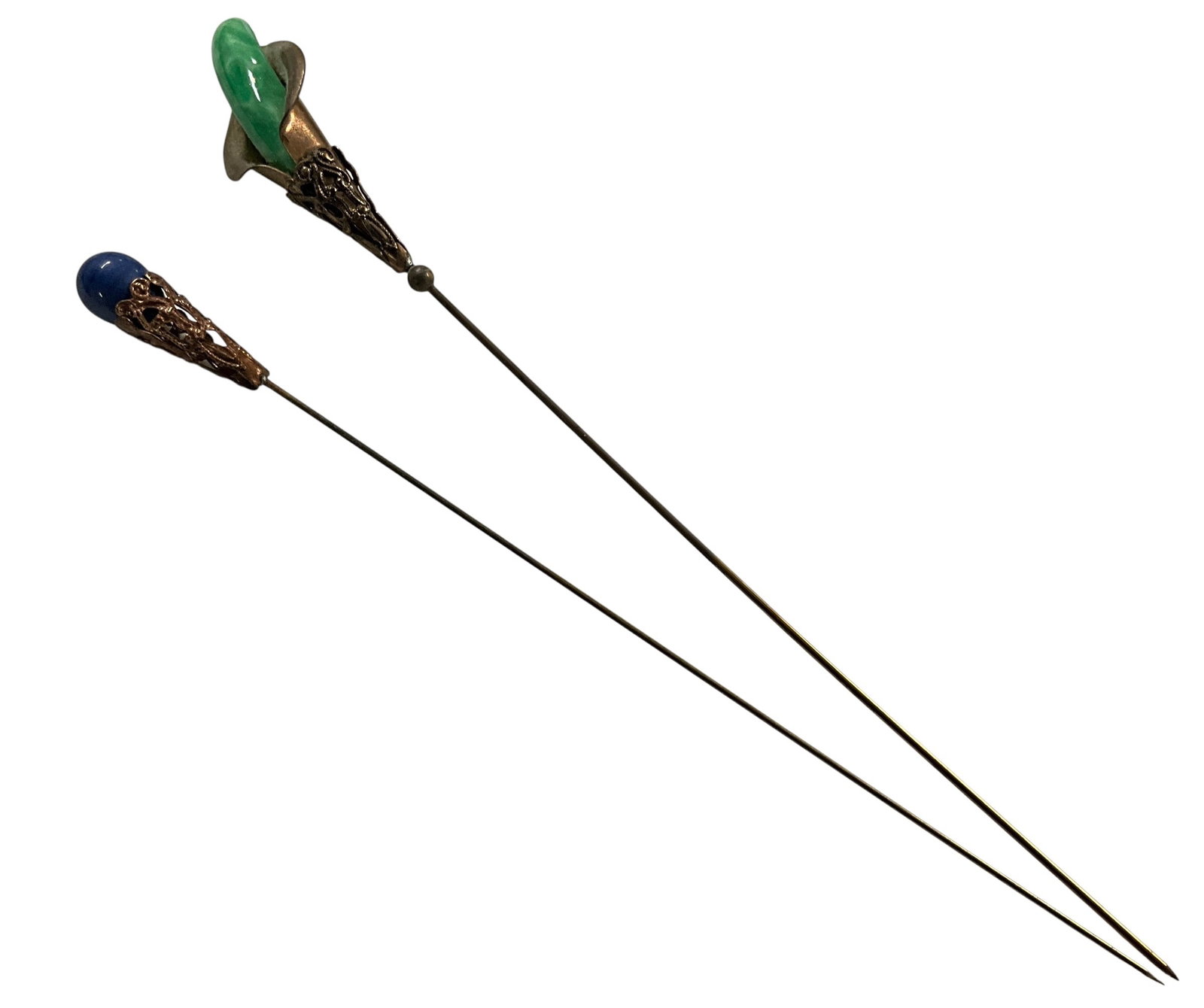 Pair of Vintage Hat Pins with Green and Blue Stone Finials: Pair of antique hat pins featuring green and blue stone tops set in decorative mounts, mounted on long shafts.