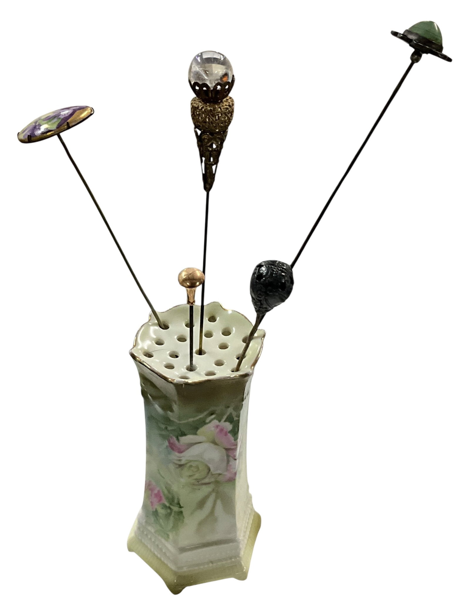Antique Porcelain Hatpin Holder with Hand-Painted Roses and Assorted Hatpins: Charming antique porcelain hatpin holder featuring a soft green ground with beautifully hand-painted rose decoration and a scalloped rim with subtle gilt accents. The hexagonal form includes a multi-h