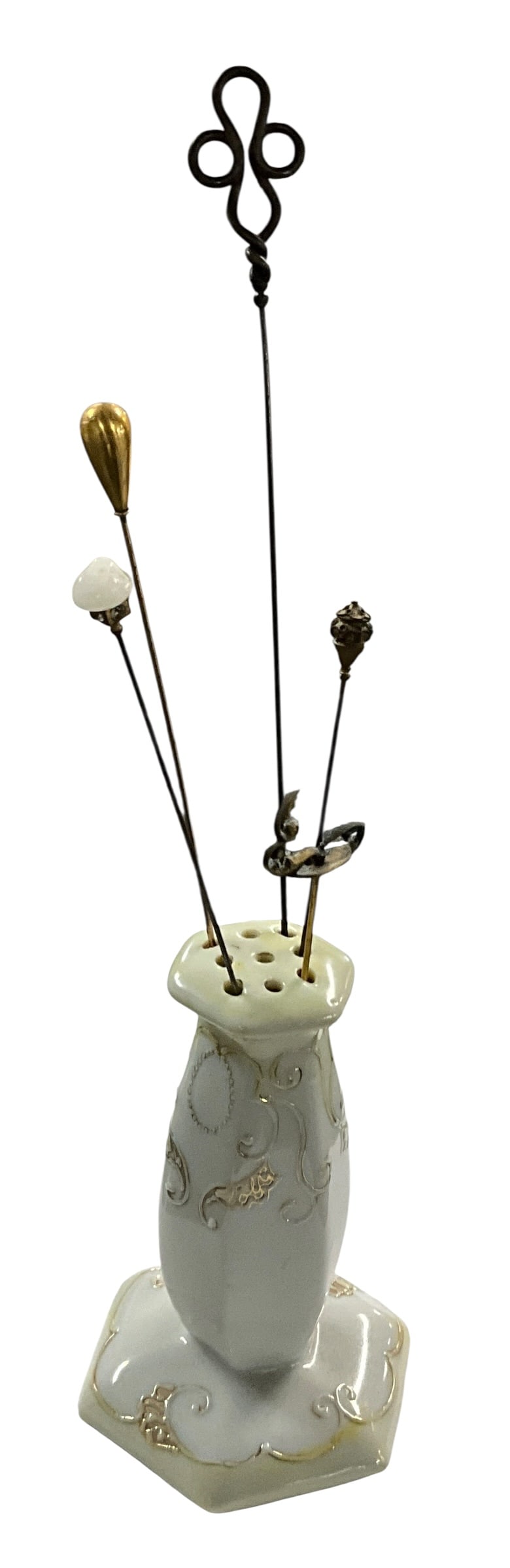 Antique Nippon Hand-Painted Porcelain Hatpin Holder with Five Assorted Hatpins: Antique porcelain hatpin holder marked Hand Painted Nippon on underside, featuring a hexagonal base and elegant raised gilt scrollwork decoration on a soft ivory ground. The form is complemented by a 