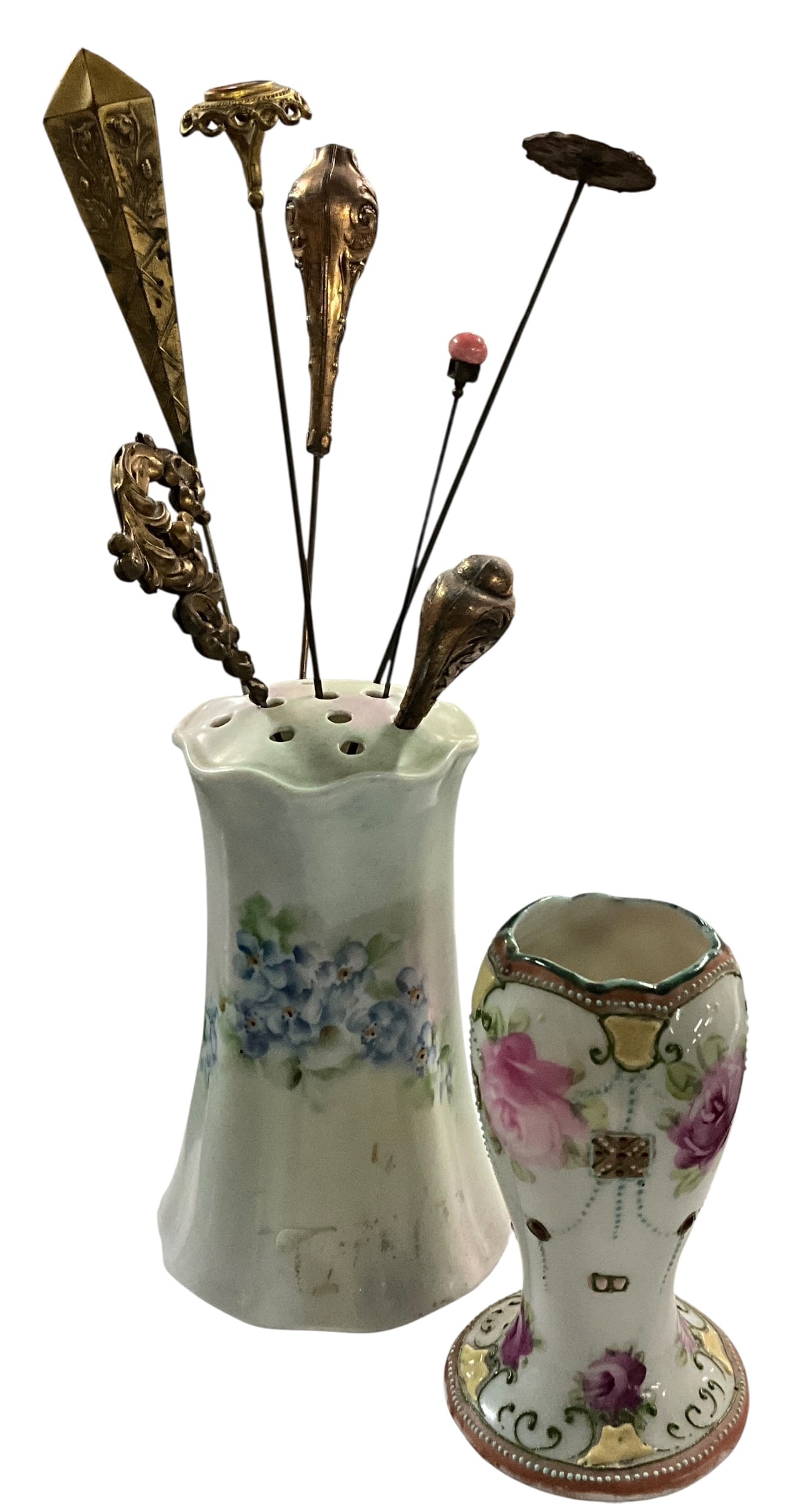 Antique Porcelain Hatpin Holders with Assorted Vintage Hatpins (2 Holders, 7 Pins): Charming grouping of antique porcelain hatpin holders accompanied by a selection of seven vintage hatpins. The larger holder features a softly flared form with hand-painted blue floral decoration and 