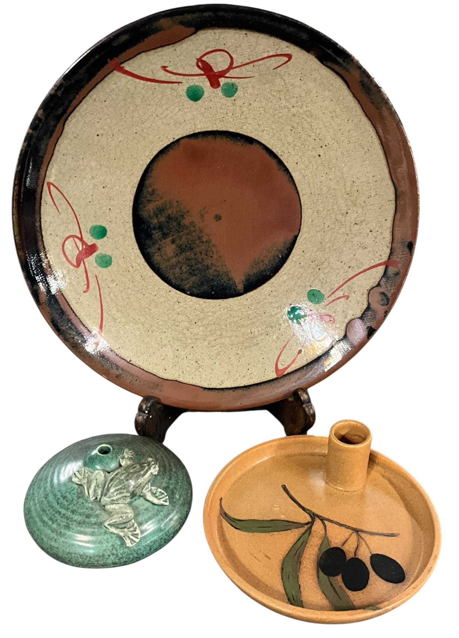 Mixed Studio Pottery Group with Plate, Candleholder and Frog Lid: A mixed group of studio pottery pieces including a large decorative plate with abstract red and green dot decoration, a small covered or lid-form piece with applied frog decoration, and a round candle