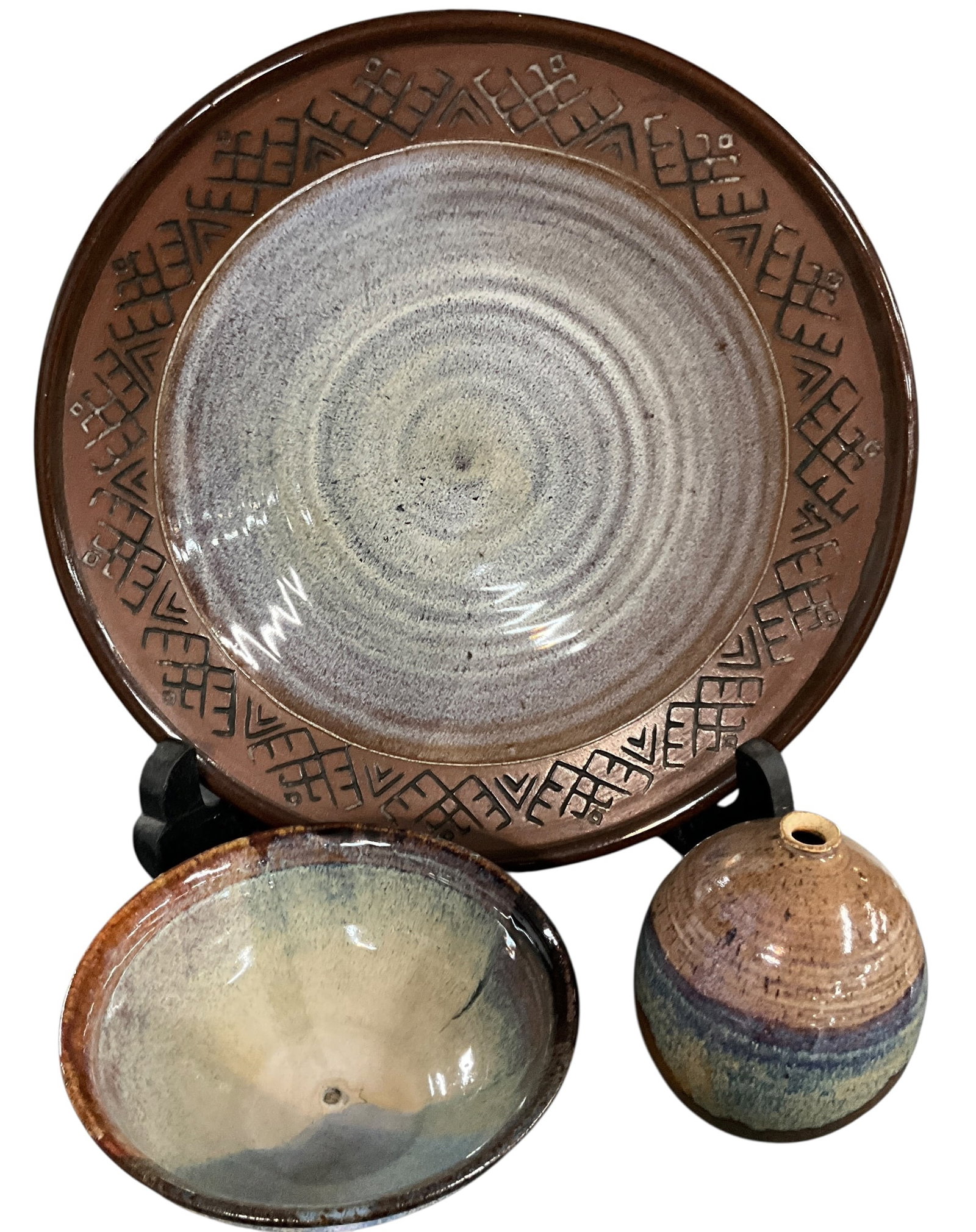 Signed Studio Pottery Plate with Bowl and Small Vase Group: A three-piece grouping of studio pottery including a large signed plate, a shallow bowl, and a small vase. The plate features a wide rim with impressed geometric decoration surrounding a concentric gl