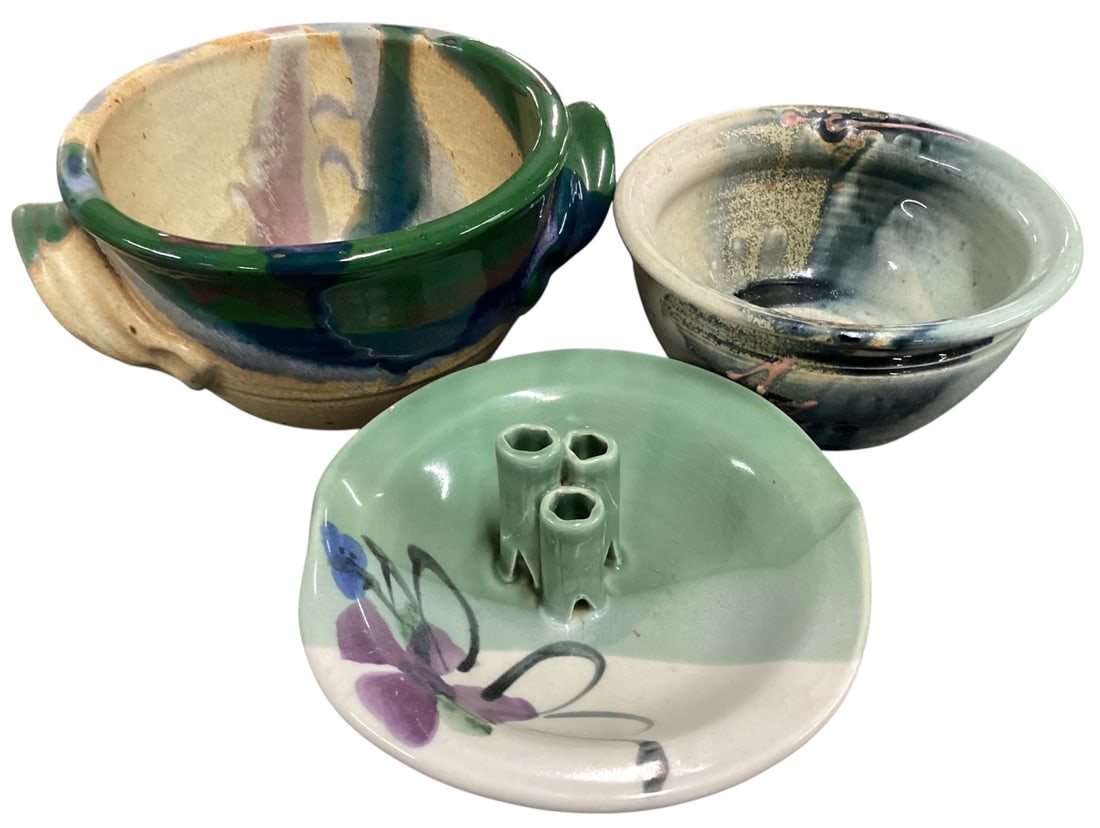 Studio Pottery Assorted Serving & Decorative Group (3 Pieces): A group of three studio pottery pieces featuring varied glazing techniques and organic forms. Includes a handled double-ear bowl with flowing green, blue, and earth-tone glaze over a buff clay body; a
