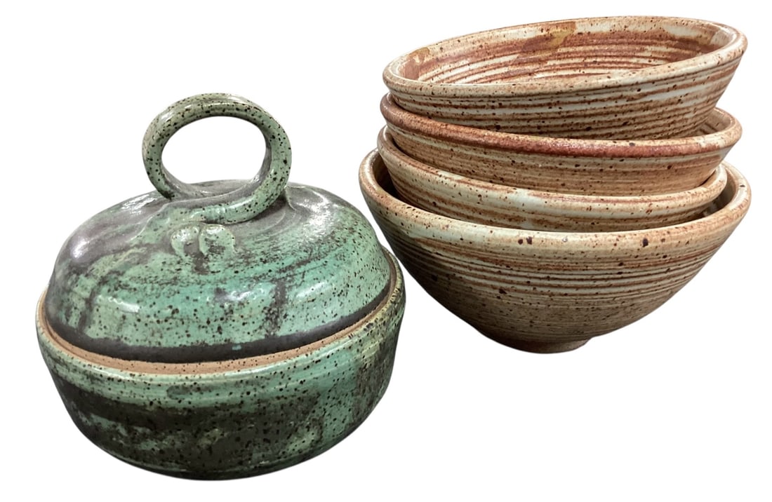 Studio Pottery Lidded Dish and Four Bowl Set: A coordinated group of studio pottery including a lidded dish and four matching bowls. The covered dish features a rounded form with fitted lid and circular loop handle, finished in a mottled green gl