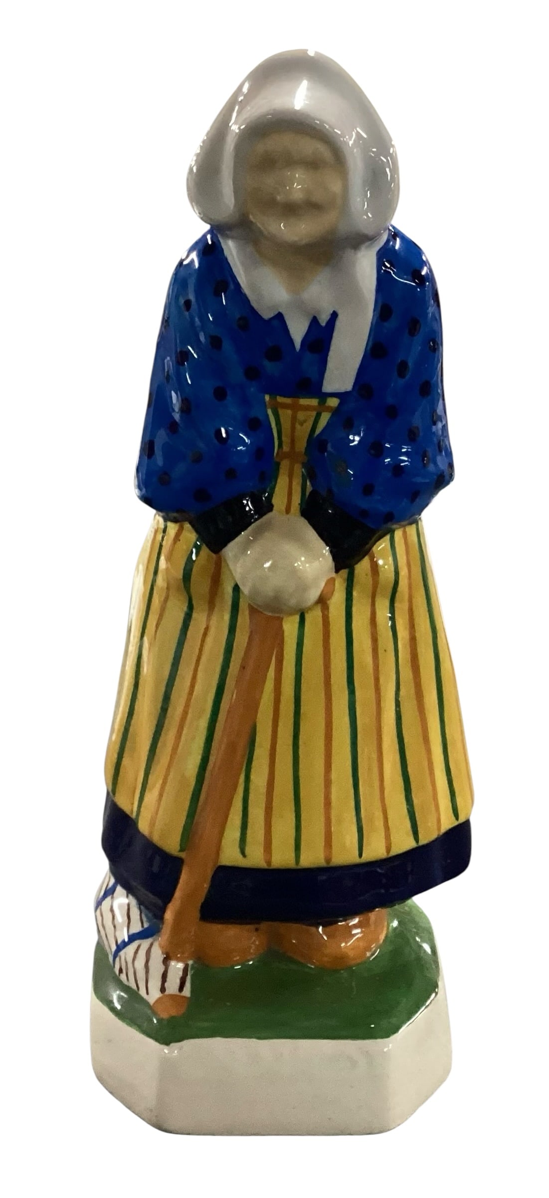 Henriot Quimper Breton Woman Faience Ceramic Figurine: Hand-painted Henriot Quimper faience ceramic figurine depicting a traditional Breton woman holding a broom beside a basket. Decorated in vibrant blue, yellow, green, and black glazes with classic regi