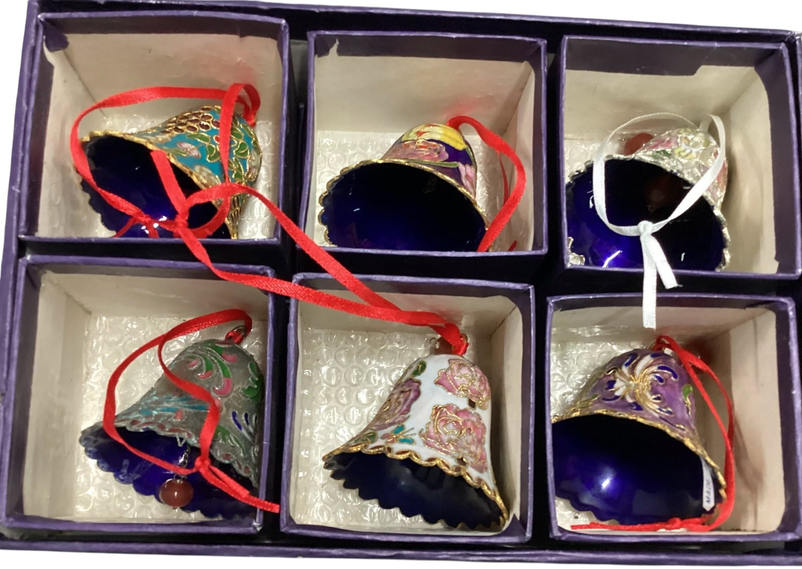 Set of Six Cloisonne Enamel Bell Ornaments with Purple Presentation Box: Set of six cloisonne enamel bell ornaments with assorted floral and fruit motifs, displayed with individual purple boxes and larger purple presentation box. Bells feature colorful enamel decoration, g