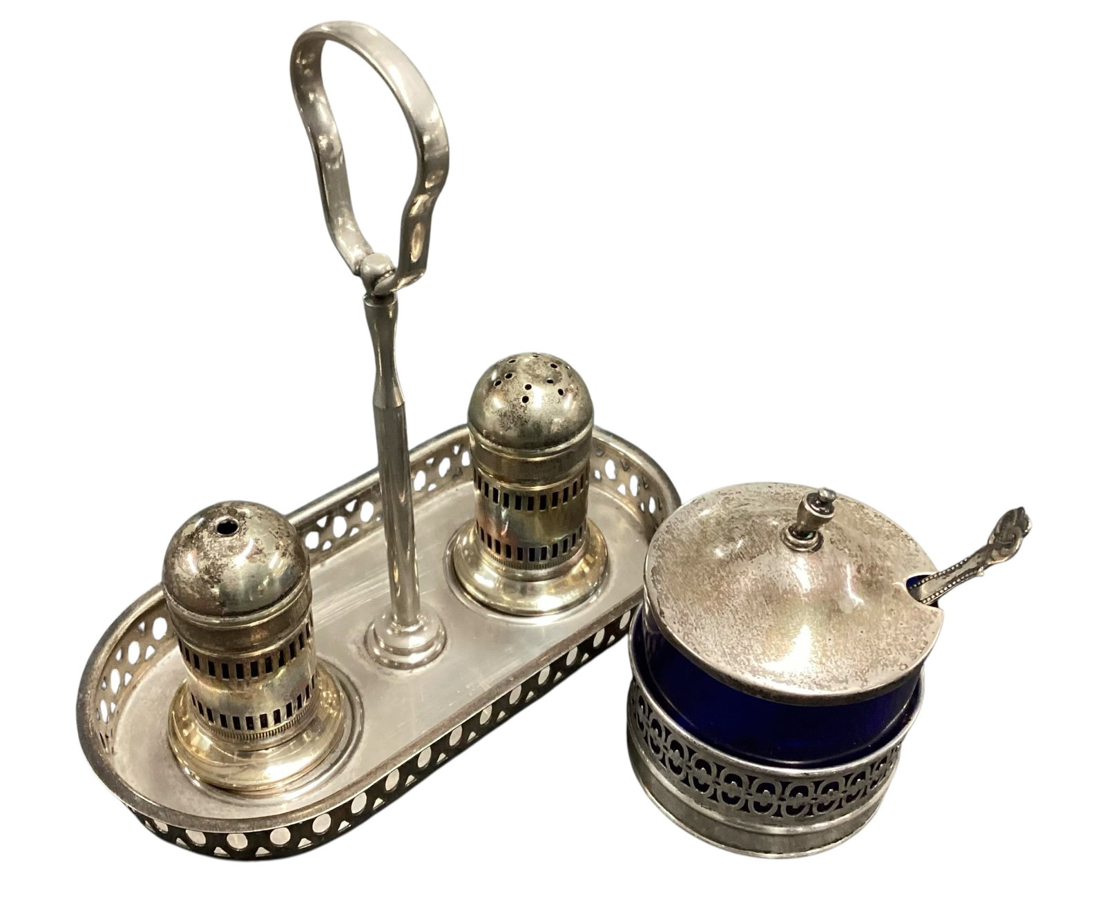 English Sterling Silver & Silver Plate Cruet Stand with Cobalt Glass Mustard Pot: Vintage English tabletop cruet or condiment stand featuring a sterling silver handled frame with matching silver plate salt and pepper shakers and a cobalt blue glass mustard pot with silver overlay a