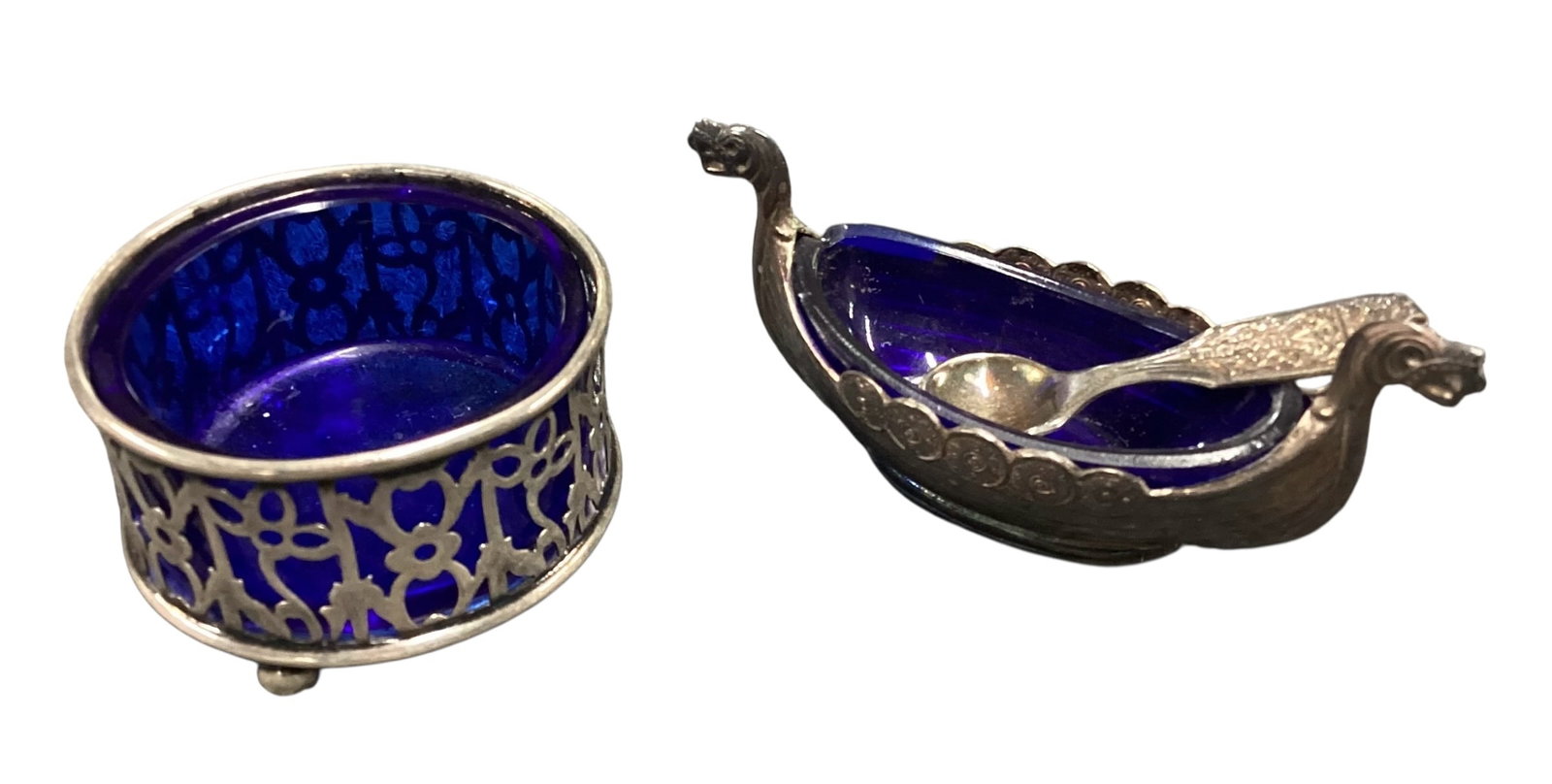 Sterling Silver Mounted Cobalt Glass Open Salt & Silver Plate Viking Ship Salt Cellar Group: Collection of antique cobalt blue glass salt cellars including an English pierced sterling silver open salt with removable cobalt glass liner, hallmarked sterling, together with a Scandinavian-style V