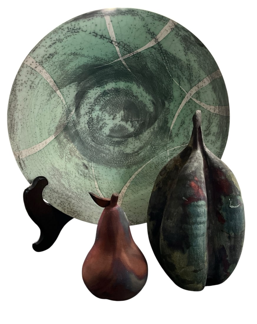 Signed Studio Pottery Raku Bowl with Decorative Fruit Sculptures: Artistic studio pottery grouping featuring a large hand-thrown raku-fired centerpiece bowl with crackle glaze decoration in celadon green, cream, and charcoal tones, together with two stylized carved 