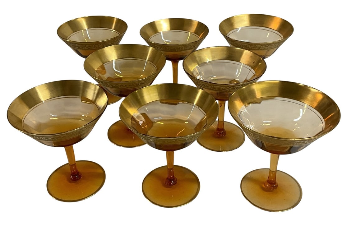 Set of Eight Amber Glass Champagne Glasses with Gold Encrusted Decoration: Vintage set of eight elegant amber glass champagne glasses featuring shallow bowl forms, slender stems, and richly decorated gold encrusted rims with scrolling ornamental motifs. Attractive