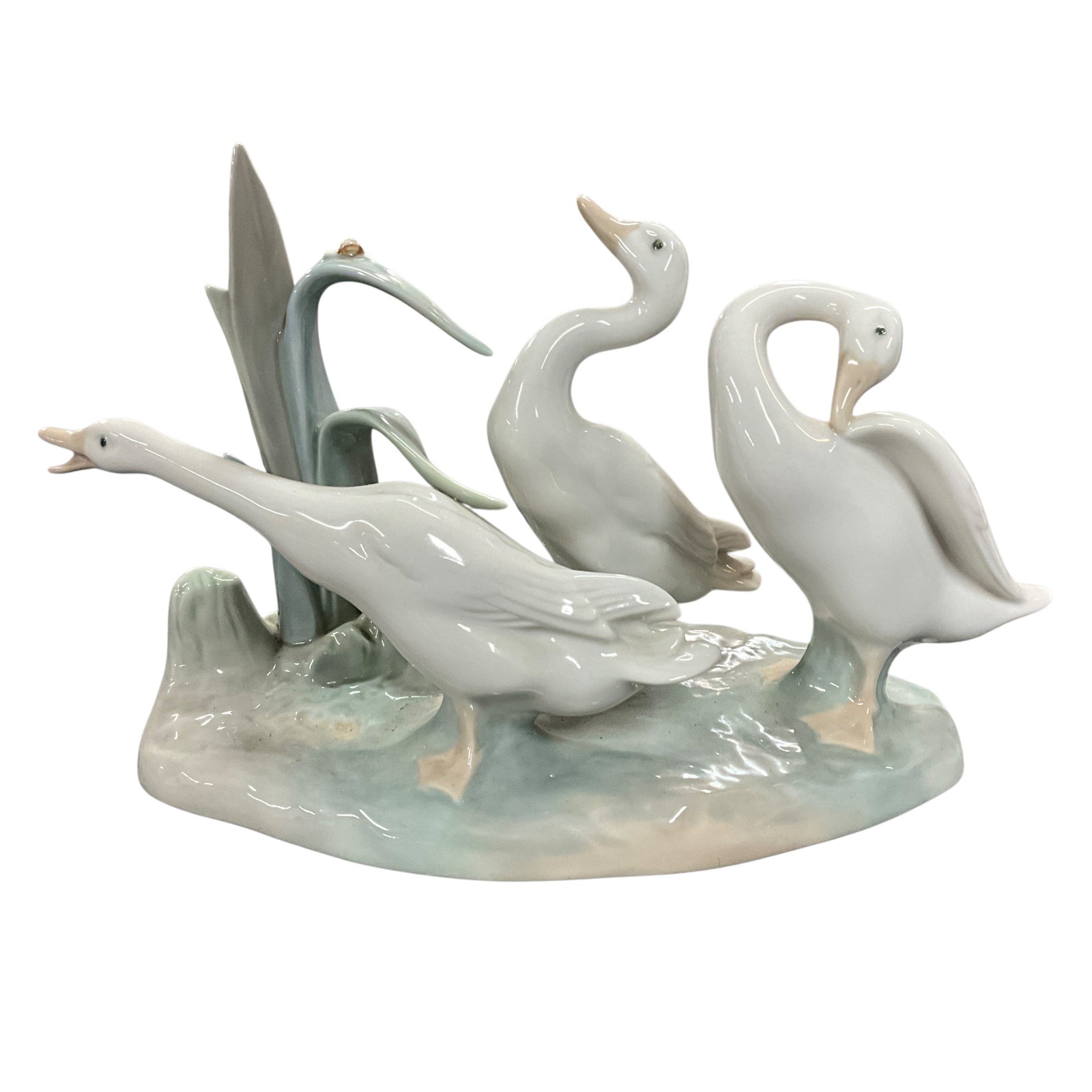 Lladro Oasis Porcelain Waterfowl Figurine Group: Glazed porcelain figural grouping by Lladro, titled â€œOasis,â€? depicting three stylized waterfowl among reeds and marsh elements. Finished in soft white and celadon tones with