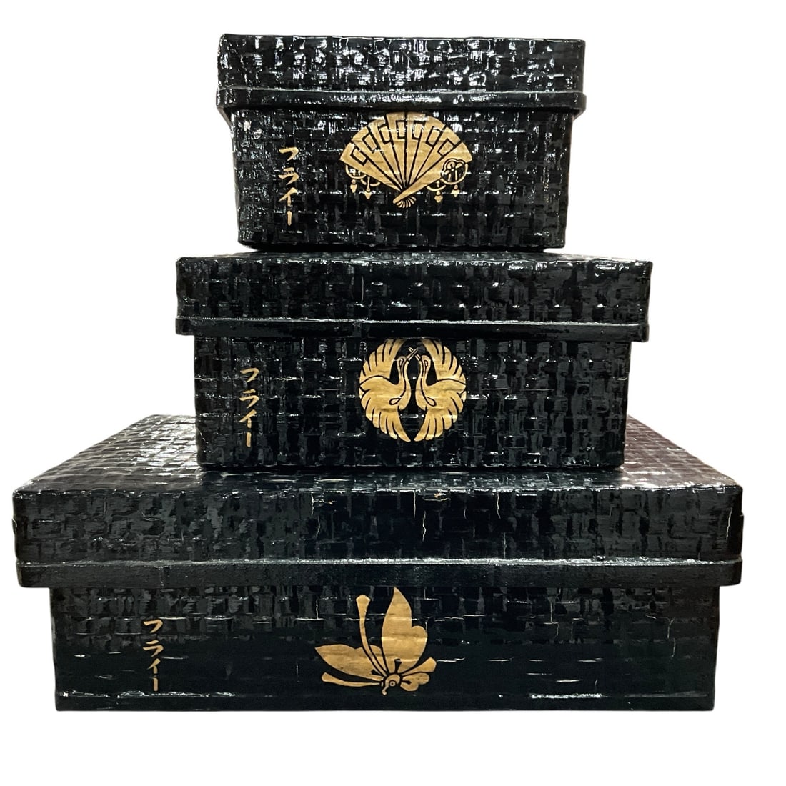 Graduated Set of Three Asian Style Decorative Storage Boxes: Graduated set of three black lacquered decorative storage boxes featuring textured faux woven surfaces with gilt Asian-inspired motifs and script decoration. Includes three fitted lidded boxes in desc