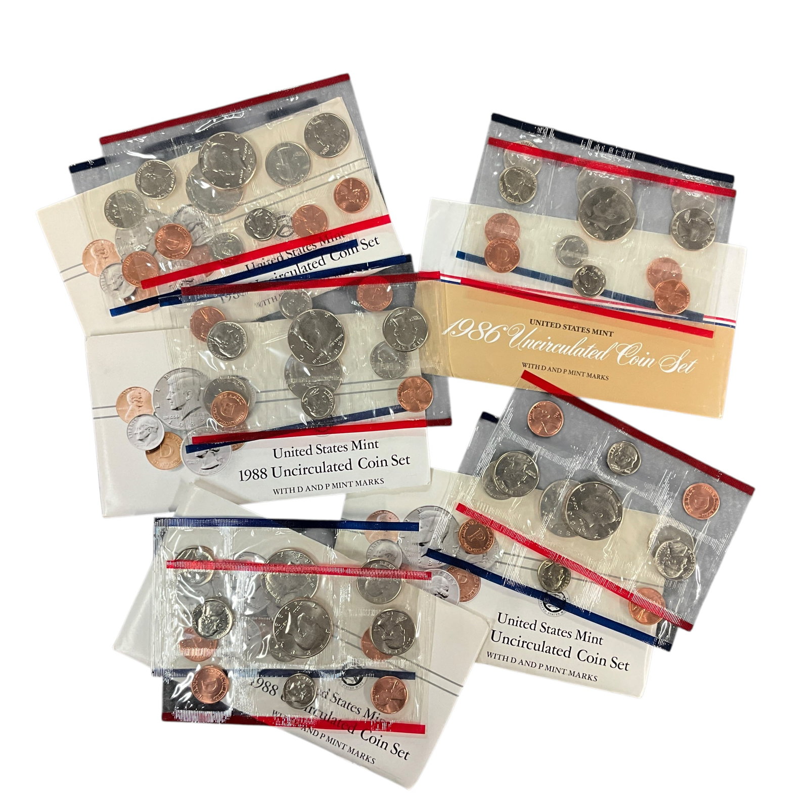 Group of United States Mint Uncirculated Coin Sets: Group of United States Mint Uncirculated Coin Sets including 1986 and multiple 1988 sets, with original envelopes and red/blue Mint-pack coin sleeves.