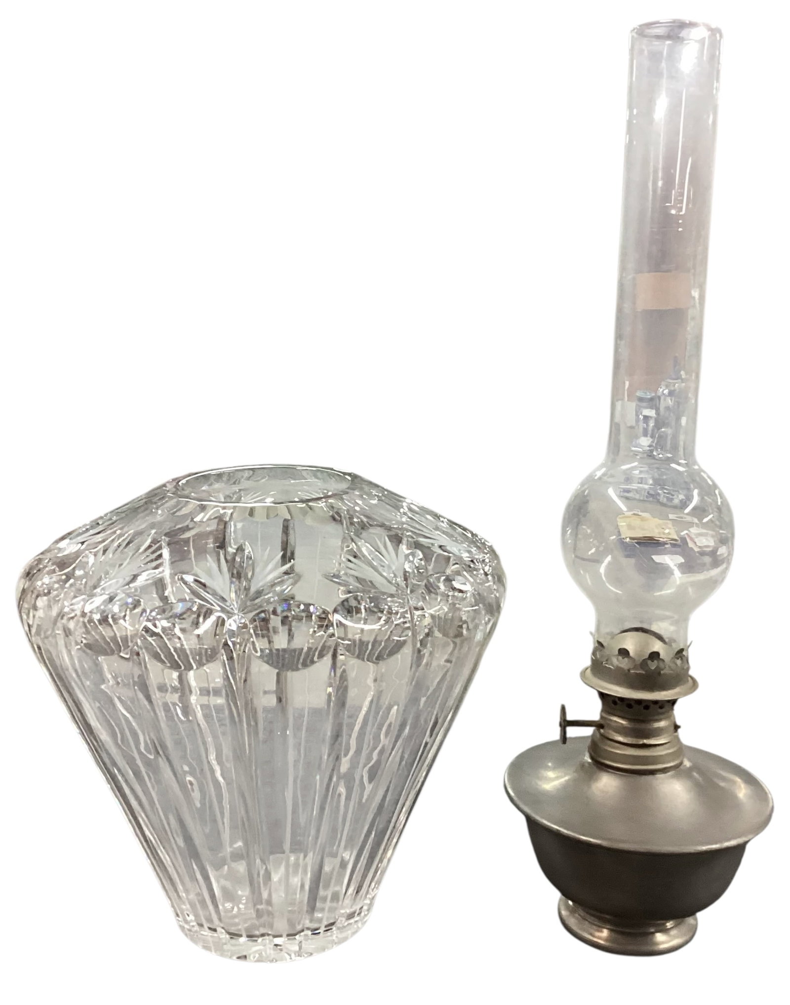 Cut Crystal Vase & International Pewter Miniature Oil Lamp: Decorative grouping featuring a heavy cut crystal vase with starburst and vertical panel cut design, together with a miniature oil lamp having a clear glass chimney and pewter base marked “Internati