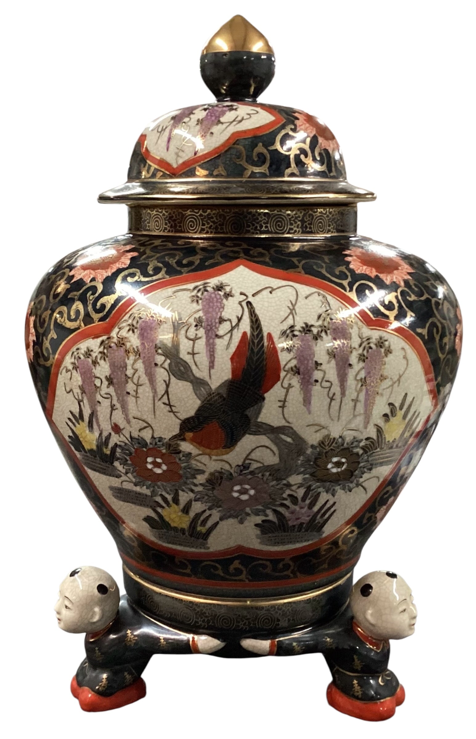 Vintage Japanese Satsuma Style Covered Temple Jar with Figural Base: Decorative vintage Japanese porcelain covered jar in the Satsuma style, featuring hand-painted birds, floral motifs, and cascading wisteria against a crackle-glazed ground with gilt scrolling decorati