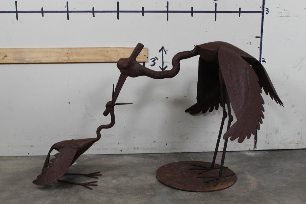 (2) Big Metal Crane Sculptures by Efrain Gutierrez: 2 Big Metal Sculptures by Efrain Gutierrez. There is a Mother Crane feeding her Baby Crane. They are crafted out of welded metal scrap, old tools and wrought iron. The Mother Crane measures 37" Long