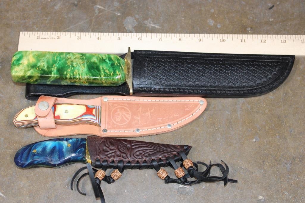 (3) Fixed Blade KNIVES with Matching Leather Sheaths: 3 Fixed Blade KNIVES with Matching Leather Sheaths. The large Knife measures 12.75" Long and has a green wooden handle. The next measures 7" Long and has a dyed wood handle. The last has a blue resin