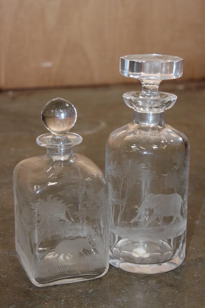 (2) Rowland Ward Queen Lace Crystal Decanters from the 1960s: 2 Vintage Rowland Ward Queen Lace Crystal Decanters. They are part of the Kenyan/African Wildlife series. These were hand-blown, hand-cut, and hand-polished in Germany. The Larger Decanter features an