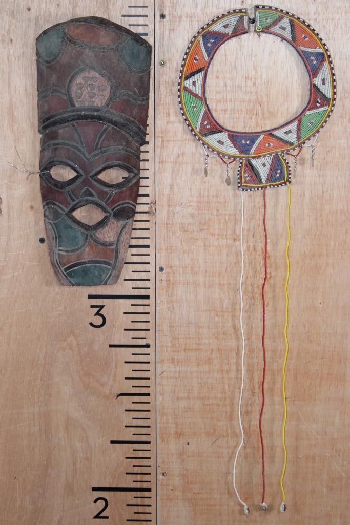 (1) Hand-carved Wood African MASK and (1) Beaded MAASAI Wedding Collar: 1 Small African MASK Hand-carved and painted from wood. 1 Traditional Beaded MAASAI Wedding Collar. The Maasai wedding necklace is also called an "enkarewa". These intricate pieces of African