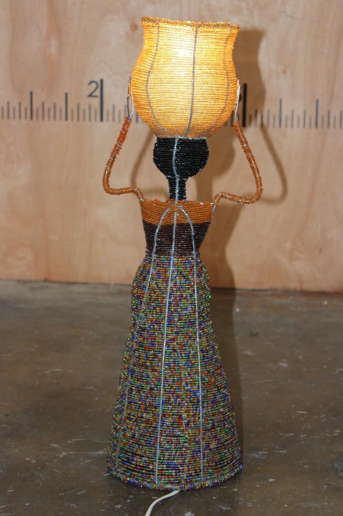 Beaded Sculptural African Woman Lamp: Handmade Sculptural African Woman Lamp in working condition. It is made from Beads and Wires and measures 23" Tall x 7" Wide (Diameter at the skirt). COLLECTIBLE AFRICAN ART LAMPS 