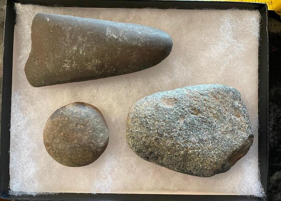 (2) Very Old Primitive STONE AXE Heads and (1) Hammerstone or Grinding Stone: 2 Very Old Primitive Grooved STONE AXE Heads and 1 Hammerstone or Grinding Stone found in Ohio. The grooved Axe Heads measure approximately 4" Long x 4" Wide and 6" Long x 2.5" Wide. The