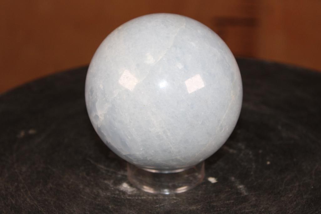 Polished BLUE CELESTITE Sphere with a Ring Stand: Polished BLUE CELESTITE Sphere. It measures 3.5" in Diameter and Weighs 2.05 lbs. It comes with a Ring Stand for display. Blue Celestite is a delicate, sky blue strontium sulfate mineral named for