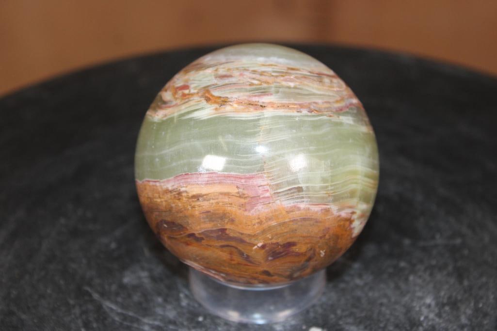 Polished GREEN BANDED ONYX Mineral Sphere: Polished GREEN BANDED ONYX Mineral Sphere. It measures 3" in Diameter and Weighs 1.3 lbs. It comes with a plastic ring stand for display. ROCKS FOSSILS MINERALS 