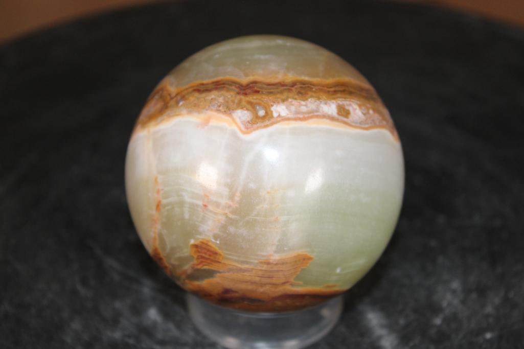 Polished GREEN BANDED ONYX Mineral Sphere: Polished GREEN BANDED ONYX Mineral Sphere. It measures 3" in Diameter and Weighs 1.3 lbs. It comes with a plastic ring stand for display. ROCKS FOSSILS MINERALS 