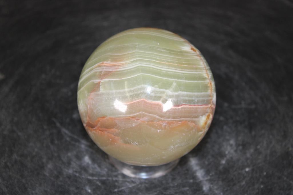 Polished GREEN BANDED ONYX Mineral Sphere: Polished GREEN BANDED ONYX Mineral Sphere. It measures 3" in Diameter and Weighs 1.3 lbs. It comes with a plastic ring stand for display. ROCKS FOSSILS MINERALS 